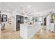 Modern white kitchen featuring an island, stainless steel appliances and tile floors at 5340 Pilots Pl, New Port Richey, FL 34652