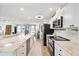 Bright, open kitchen featuring marble countertops, modern appliances, and easy access to the living room at 5340 Pilots Pl, New Port Richey, FL 34652
