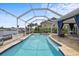 Sparkling pool area with a screened enclosure, a spacious patio, and relaxing outdoor seating for enjoying the Florida sunshine at 5340 Pilots Pl, New Port Richey, FL 34652