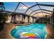 Inviting pool area with screened enclosure, spacious patio, and relaxing views for ultimate outdoor enjoyment at 5340 Pilots Pl, New Port Richey, FL 34652