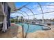 Sparkling pool area with a screened enclosure, perfect for enjoying the outdoors while maintaining a pest-free environment at 5340 Pilots Pl, New Port Richey, FL 34652