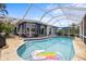Inviting pool area with an enclosing screen, spacious patio, and comfortable outdoor seating for ultimate relaxation at 5340 Pilots Pl, New Port Richey, FL 34652