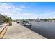 Scenic waterfront view showcasing a private dock, boat lift, and easy access to the open water at 5340 Pilots Pl, New Port Richey, FL 34652