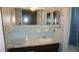 The bathroom features blue tile, a marble countertop, and floral wallpaper at 5636 Dolores Dr, Holiday, FL 34690
