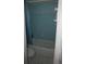 This bathroom features a tiled shower/tub, toilet, and blue accents at 5636 Dolores Dr, Holiday, FL 34690