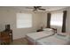 Bedroom features two twin beds, ceiling fan, and large window for natural light at 5636 Dolores Dr, Holiday, FL 34690