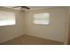 This bedroom features a window with blinds, ceiling fan, and outlets at 5636 Dolores Dr, Holiday, FL 34690