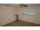 A simple bedroom features a ceiling fan, a window with blinds, and beige walls at 5636 Dolores Dr, Holiday, FL 34690