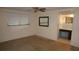 This bedroom features a ceiling fan, window with blinds, and an adjacent bathroom at 5636 Dolores Dr, Holiday, FL 34690