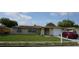 Charming single-story home with a well-manicured lawn, front door gate and a cozy, inviting curb appeal at 5636 Dolores Dr, Holiday, FL 34690