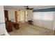 Cozy living room with natural light, neutral walls, and vintage decor at 5636 Dolores Dr, Holiday, FL 34690