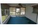 The sunroom has screens, windows, and blue carpeting at 5636 Dolores Dr, Holiday, FL 34690