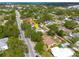 Street view of a beautiful single-Gathering home surrounded by mature trees and lush greenery in a serene neighborhood setting at 6207 Main St, New Port Richey, FL 34653