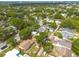 Overhead view of a residential neighborhood filled with mature trees and a clear blue sky at 6207 Main St, New Port Richey, FL 34653