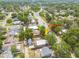 An aerial view showcasing a lovely single-Gathering home in a peaceful neighborhood with road access, garage and outbuilding at 6207 Main St, New Port Richey, FL 34653