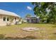 A spacious backyard featuring a seating area, a garage, and an outdoor fire pit at 6207 Main St, New Port Richey, FL 34653