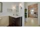 Hallway leading to a vanity, next to a storage space at 6207 Main St, New Port Richey, FL 34653