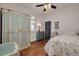Cozy bedroom with wooden floors, painted wardrobe, and floral bedding at 6207 Main St, New Port Richey, FL 34653