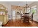 Charming dining area with hardwood floors, chandelier, and open access to the kitchen at 6207 Main St, New Port Richey, FL 34653
