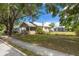 A charming home with a metal roof and detached garage is complemented by a well-manicured lawn at 6207 Main St, New Port Richey, FL 34653