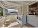 A bright laundry room with washer and dryer, plus a view to the backyard at 6207 Main St, New Port Richey, FL 34653