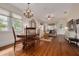 Open-concept living area with hardwood floors, connecting to dining space and abundant natural light at 6207 Main St, New Port Richey, FL 34653