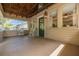 Charming covered porch featuring rocking chairs, a side table, and views of the lush outdoors at 6207 Main St, New Port Richey, FL 34653
