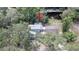 Aerial view of the home surrounded by lush trees and vegetation showcasing the roof and yard at 6234 Cyril Dr, Dade City, FL 33523