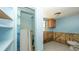 Bathroom features a shower, window, blue walls, and tile floors, ready for upgrades and personalization at 6234 Cyril Dr, Dade City, FL 33523