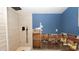 Bathroom with a shower, blue walls, with areas unfinished, showing wall studs at 6234 Cyril Dr, Dade City, FL 33523