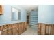 Bathroom featuring a mirror, blue walls, tile floors, and shelves ready for renovation and upgrades at 6234 Cyril Dr, Dade City, FL 33523