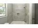 Bathroom showing tiled walls around the bathtub and a shower with a built-in niche at 6234 Cyril Dr, Dade City, FL 33523