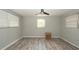 This bedroom has wood-look flooring and natural light from three windows at 6234 Cyril Dr, Dade City, FL 33523