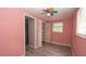 Cozy bedroom features a colorful ceiling fan, wood-look floors, and an adjacent closet at 6234 Cyril Dr, Dade City, FL 33523
