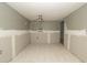 Bedroom featuring neutral walls, tile flooring, ceiling fan, and air conditioning unit ready to be updated at 6234 Cyril Dr, Dade City, FL 33523