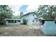 Two-story home with mature trees, covered patio, and an outdoor brick oven at 6234 Cyril Dr, Dade City, FL 33523