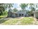 Two-story home featuring a spacious backyard with mature trees, offering an inviting outdoor space at 6234 Cyril Dr, Dade City, FL 33523