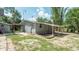 Backyard of home features a patio space, grassy area, and some tree coverage at 6234 Cyril Dr, Dade City, FL 33523