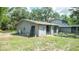 View of the home's rear with patio and glass doors, enhancing indoor-outdoor living at 6234 Cyril Dr, Dade City, FL 33523