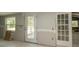 An unfinished kitchen with natural light coming through the window and the door at 6234 Cyril Dr, Dade City, FL 33523