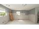 Living room showing an incomplete remodel with new flooring and unpainted drywall at 6234 Cyril Dr, Dade City, FL 33523