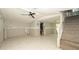 Large living area with tile flooring, stairs, and a partial view of the connected bathroom at 6234 Cyril Dr, Dade City, FL 33523
