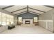 Living room with tall ceilings featuring a fireplace, newly installed floors, and bare drywall at 6234 Cyril Dr, Dade City, FL 33523