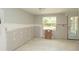 Bright room featuring tile flooring, a window with natural light, and a glass panel door at 6234 Cyril Dr, Dade City, FL 33523