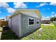 An exterior shot of the backyard of the home, featuring a wooden privacy fence and green grass at 6306 Aberdeen Ave, New Port Richey, FL 34653