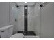 This bathroom features a tile shower with a black accent tile and a shower head at 6306 Aberdeen Ave, New Port Richey, FL 34653