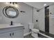 This updated bathroom features a designer black framed mirror, tile shower with black accents, and modern vanity at 6306 Aberdeen Ave, New Port Richey, FL 34653