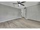 This bedroom features a view to a bathroom, spacious closet with a door, and modern ceiling fan at 6306 Aberdeen Ave, New Port Richey, FL 34653