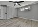 This bedroom features a spacious closet with a door, a window, and modern ceiling fan at 6306 Aberdeen Ave, New Port Richey, FL 34653