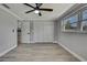 Bright bedroom featuring wood-look floors, white closet doors and a window view at 6306 Aberdeen Ave, New Port Richey, FL 34653